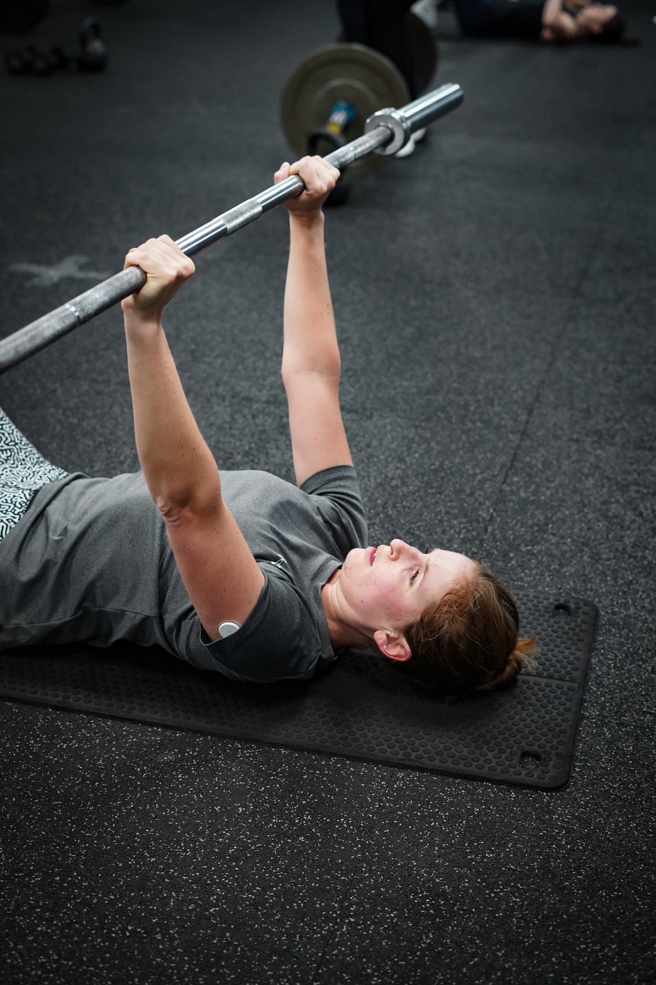 Member performing barbell bench press